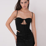 Stylish model wearing a side tie black mini skirt and a fitted top, perfect for a night out or club party.