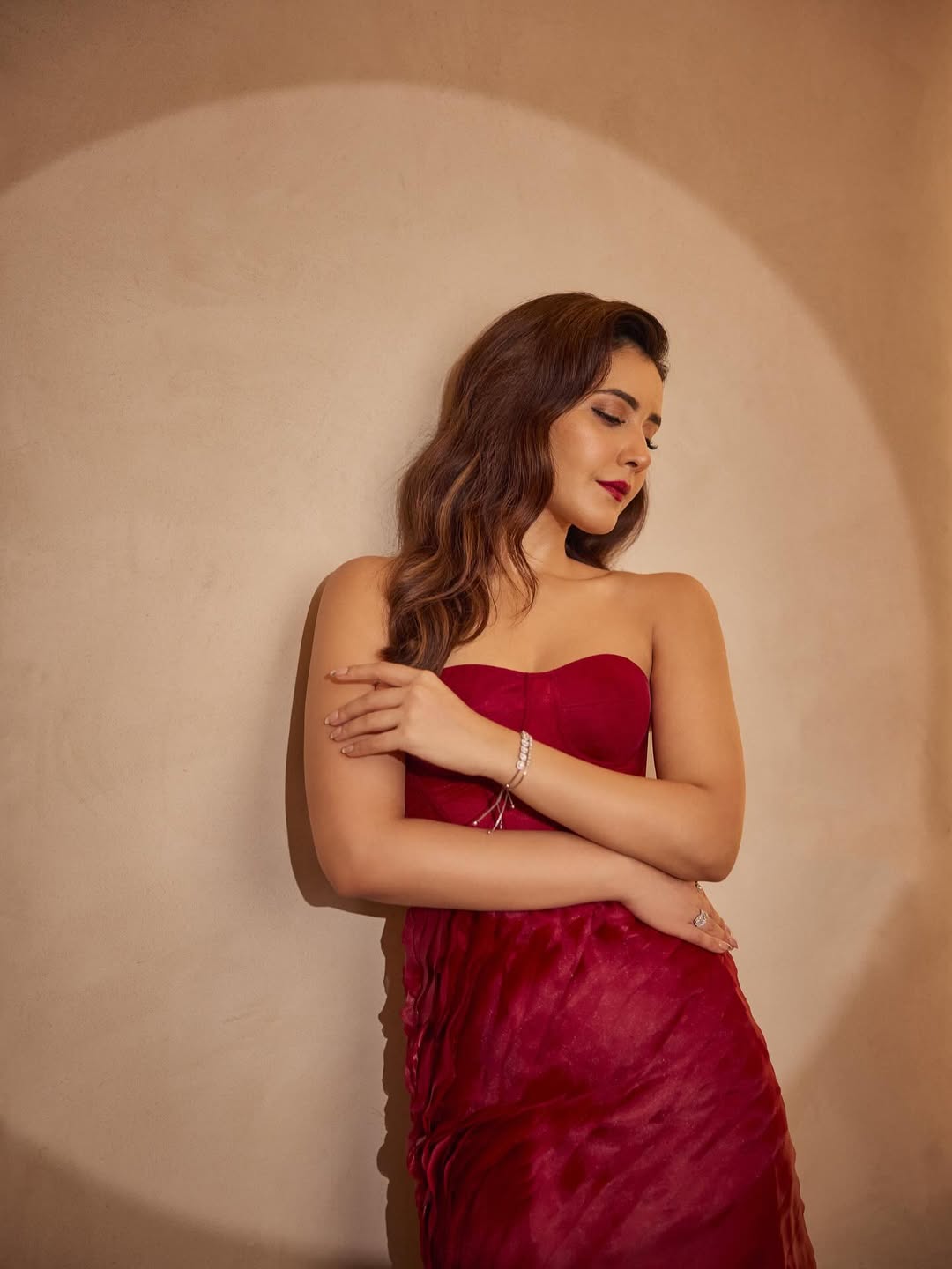Raashi Khanna in Crimson Dream Gown posting elegantly